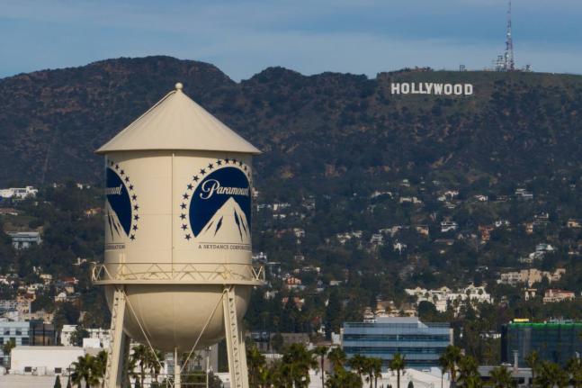The Paramount Pictures water tower is seen in Los Angeles, December 18, 2025, with the Hollywood sign in the distance.
