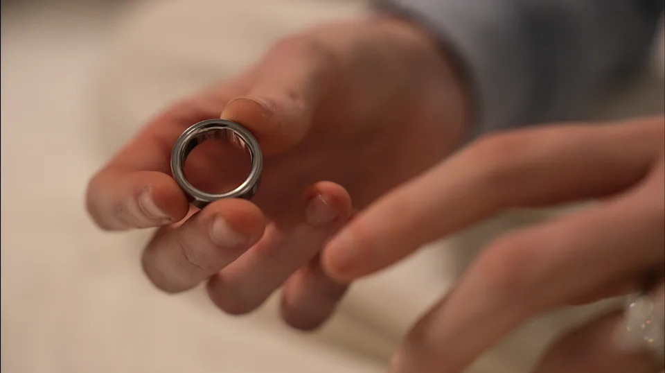 Middle school teacher Kate Stoye puts on an Oura ring, a wearable sleep tracking device, Wednesday, Jan. 7, 2026, in Hiram, Ga. (AP Photo/Emilie Megnien) · Yahoo Finance · ASSOCIATED PRESS