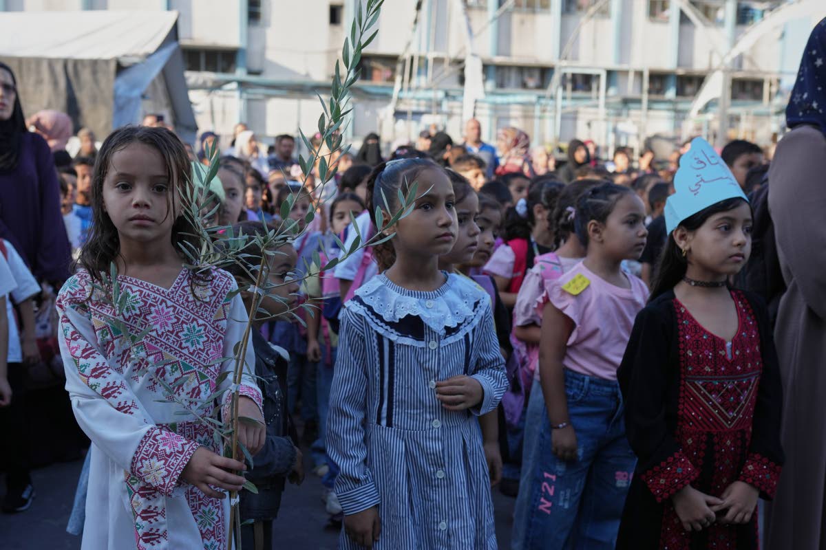 Palestinian children line up on the first day of the new academic year at an UN-run school in Nuseirat, central Gaza Strip.
