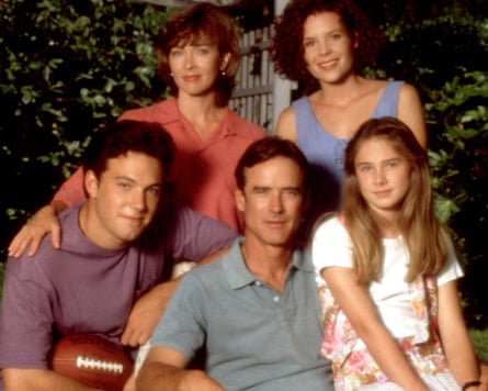 A teenage Ben Affleck holds a football, posing in a family group of father, mother and two sisters.