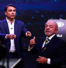 Flávio Bolsonaro e Lula durante debate da Band Foto: ALOISIO MAURICIO/FOTOARENA / Estadão